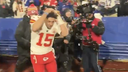 Patrick Mahomes covers his head from incoming snowballs